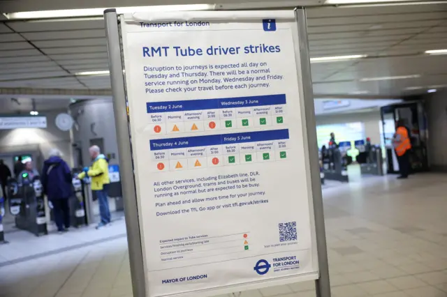A sign lists service disruption details at Hammersmith underground station, during a 24-hour tube strike