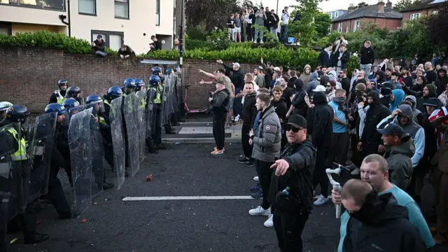 Demonstrators lined up in front of riot police