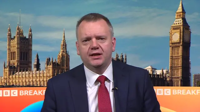 Nick Thomas-Symonds sits on the set of BBC Breakfast wearing a navy suit and red tie.