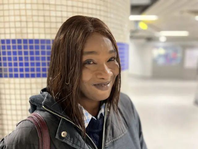 Woman with dark jacket smiles
