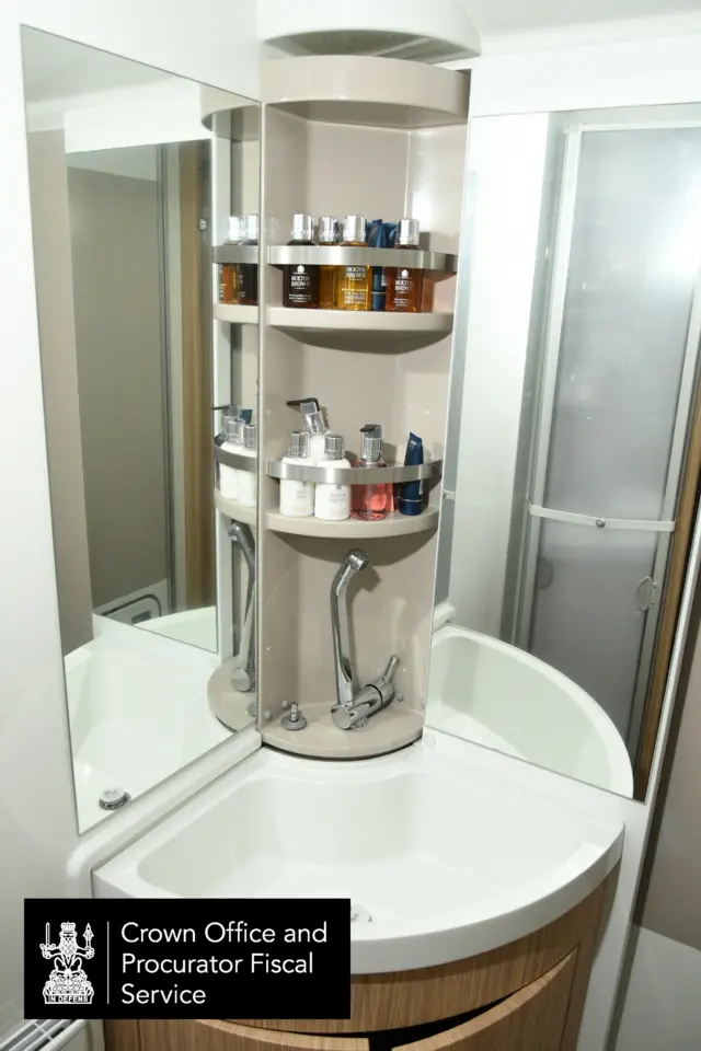 The corner sink of a bathroom inside a motorhome.