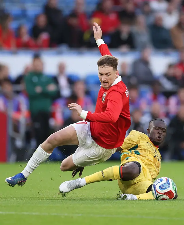 Kamaldeen Sulemana of Ghana challenges David Brooks of Wales