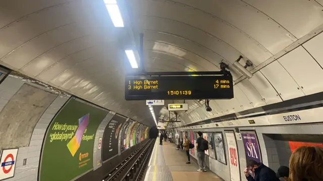Euston Underground station board showing four minutes until the first train and 17 until the third. Both trains are heading to High Barnet