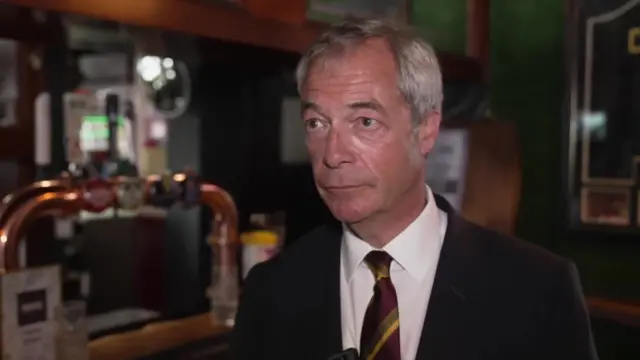 Nigel Farage looking into the left of the camera frame