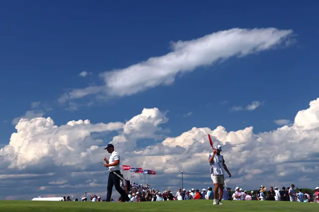 A wide shot of a green with Wyndham Clark on it
