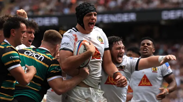 Dafydd Jenkins celebrates scoring a try