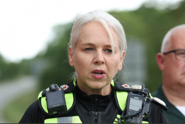 British Transport Police Chief Constable Lucy D’Orsi in black uniform and yellow hi-vi vest addressed the press