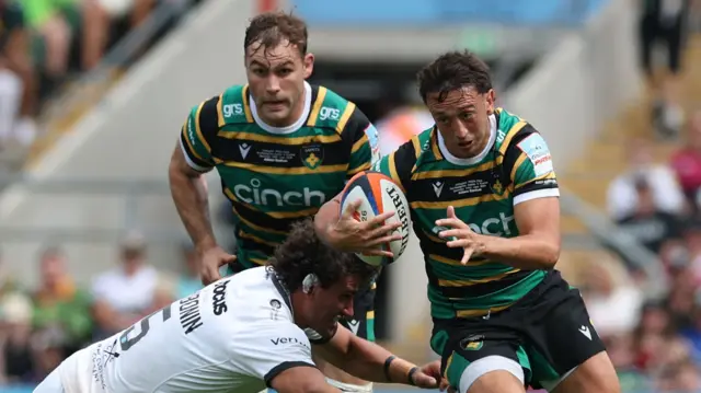 Alex Mitchell carries the ball for Northampton