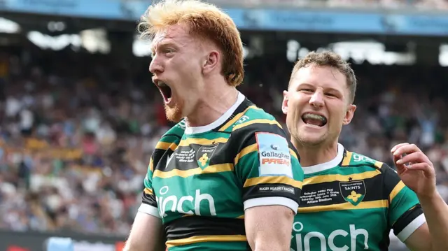 George Hendy celebrates scoring try for Northampton