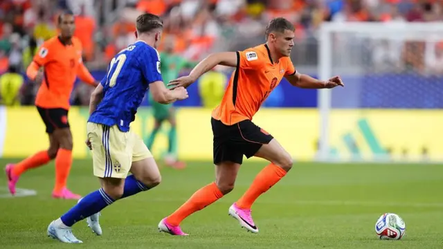 Micky Van De Ven drives the ball