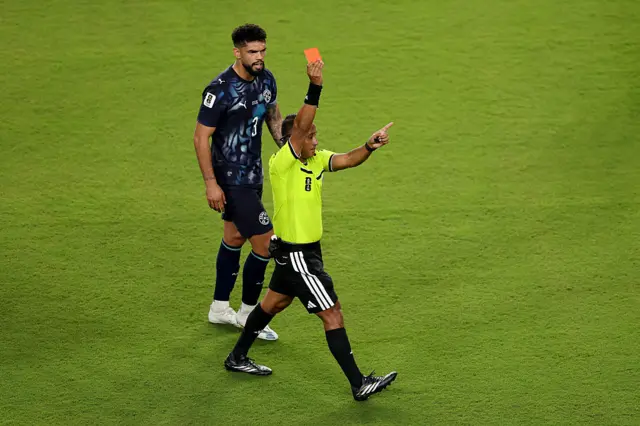 Referee Ivan Barton issues a red card to Miguel Almiron #10 (not pictured) of Paraguay for covering his mouth while talking to another player during the FIFA World Cup 2026 Group D match between Türkiye and Paraguay