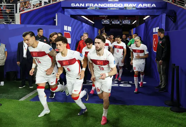 Abdulkerim Bardakci #14, Arda Guler #8 and Ismail Yuksek #16 of Turkiye run out of the tunnel with teammates during the FIFA World Cup 2026 Group D match between Türkiye and Paraguay