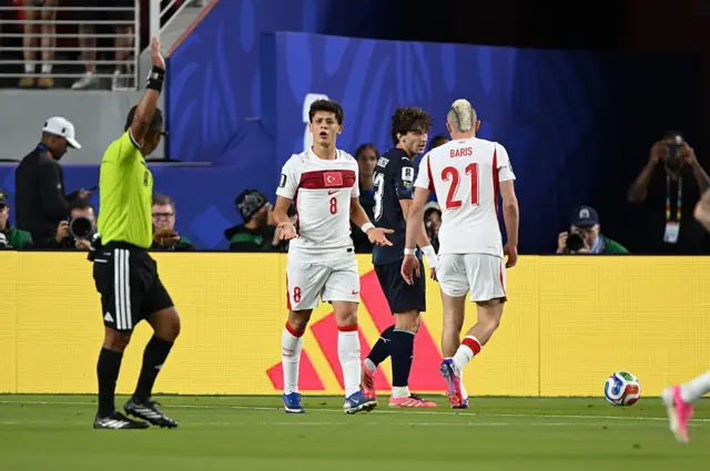 Arda Guler of Turkiye argues with the referee Ivan Arcides during the 2026 FIFA World Cup First Stage Group D match between Turkiye and Paraguay at the San Francisco Bay Area Stadium