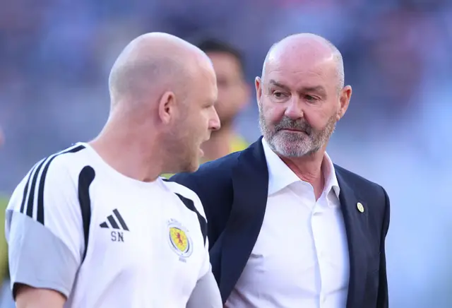 Head Coach of Scotland speaks with assistant Steven Naismith
