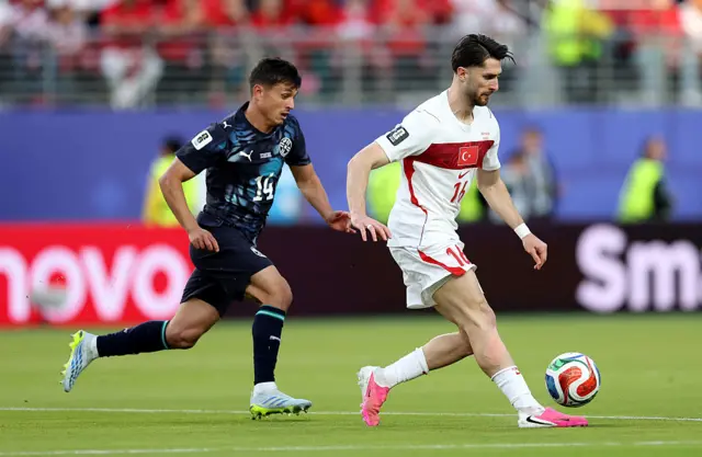 Ismail Yuksek #16 of Turkiye controls the ball under pressure from Andres Cubas #14 of Paraguay during the FIFA World Cup 2026 Group D match between Türkiye and Paraguay