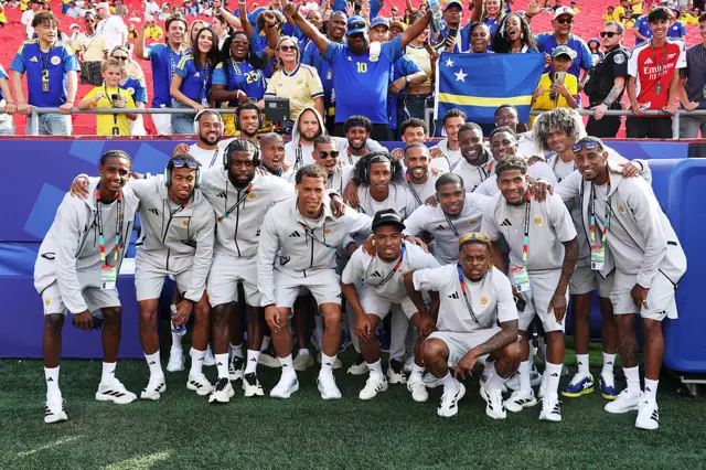 Curacao players pose for photos with fans before the FIFA World Cup 2026 Group E match between Ecuador and Curacao at Kansas City Stadium