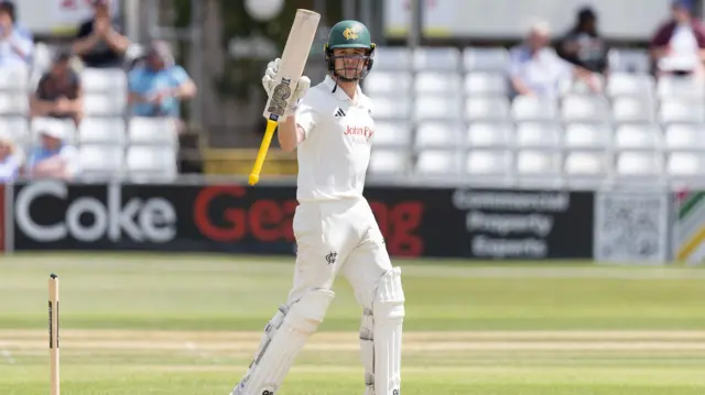 Jack Haynes raises his bat to acknowledge the applause for his half century