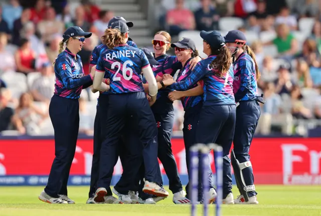Kirstie Gordon of Scotland celebrates with her teammates after taking the wicket of Amy Jones of England during the ICC Women's T20 World Cup Group B match between England and Scotland at Headingley