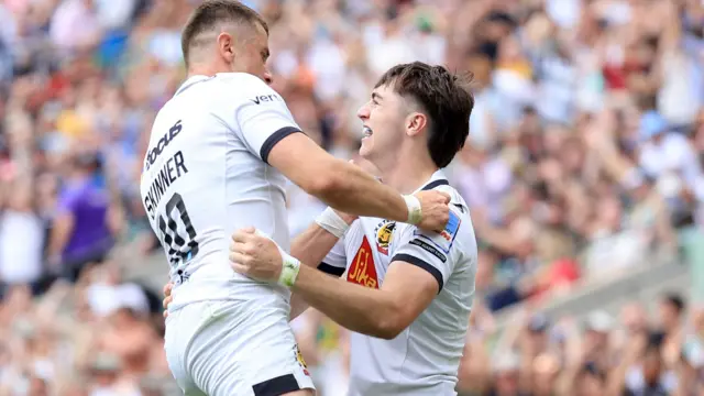 Exeter players celebrate scoring a try
