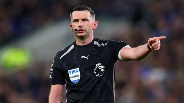 Michael Oliver points to the left during a match in which he is referee