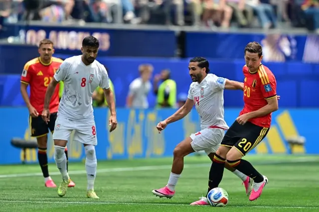 Iran's Mohammad Mohebi, Iran's Saman Ghoddos and Belgium's Hans Vanaken fight for the ball