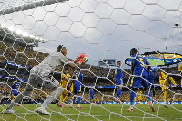 Eloy Room makes a save past Ecuador's forward #11 Kevin Rodriguez during the 2026 World Cup Group E football match between Ecuador and Curacao at the Kansas City Stadium