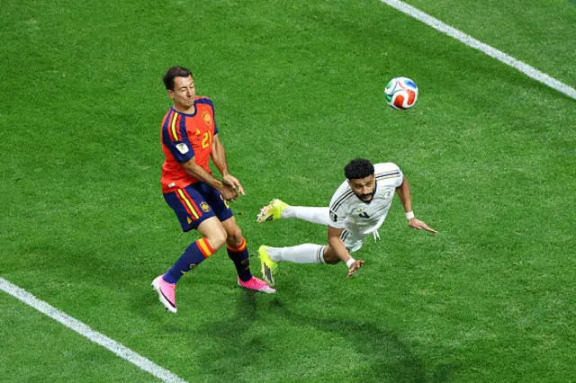 Abdulelah Al-Amri #4 of Saudi Arabia clears the ball in front of Mikel Oyarzabal
