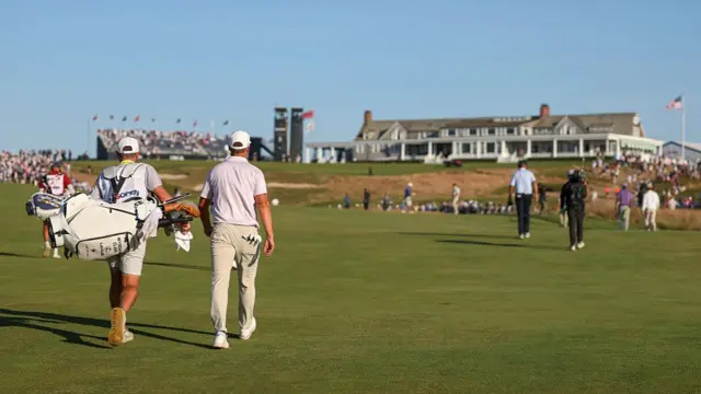 Wyndham Clark walks up 18