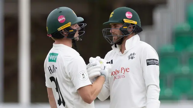 Jack Haynes shakes hands with teammate Fergus O'Neill