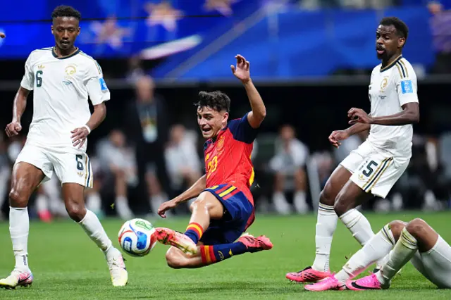 Pedri Gonzalez of Spain and Musab Aljuwayr of Saudi Arabia compete for the ball