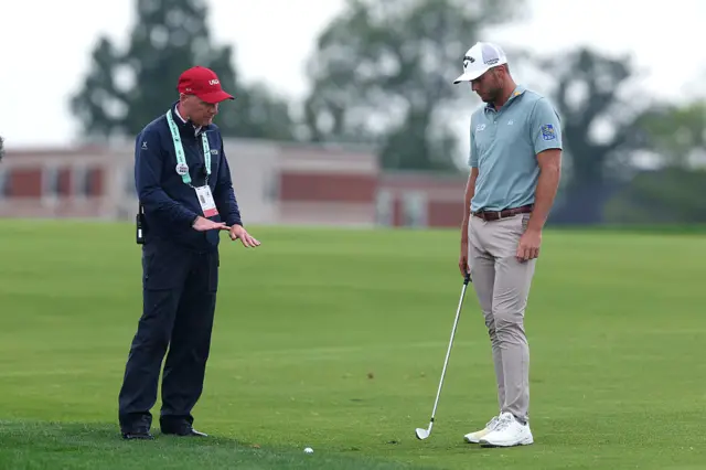 Sam Burns and a rules official