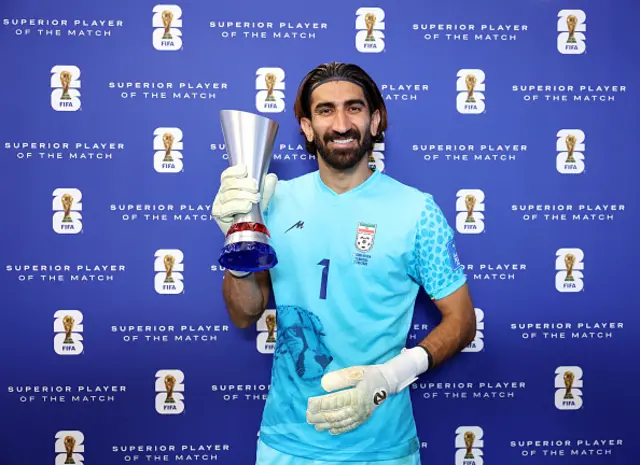 Alireza Beiranvand of IR Iran poses with the Superior Player of the Match Trophy
