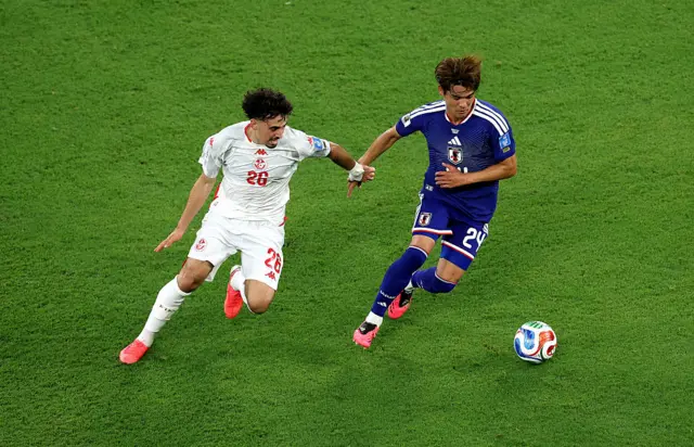 Kaishu Sano #24 of Japan is challenged by Sebastian Tounekti #26 of Tunisia during the FIFA World Cup 2026 Group F match between Tunisia and Japan