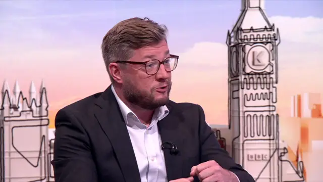 Former Starmer adviser Paul Ovenden in dark suit, mid-speech