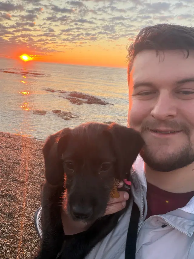 Alex and his puppy on a beach