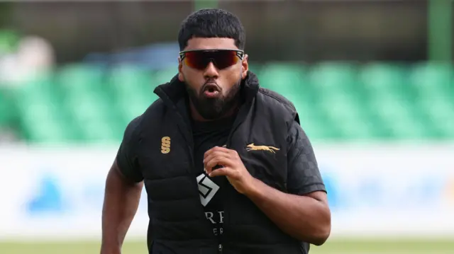 Leicestershire all-rounder Rehan Ahmed warms up with a jog before play starts