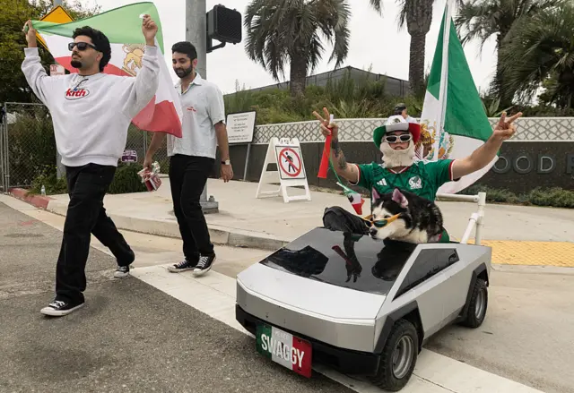 Swaggy the dog in a car outside Los Angeles Stadium