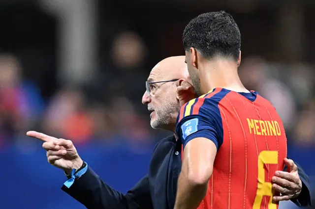 Mikel Merino (R) speaks with Spain's head coach Luis de la Fuente