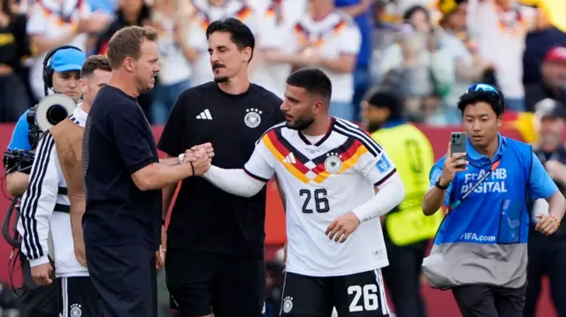 Julian Nagelsmann shakes the hand of goal hero Deniz Undav after Germany's 2-1 win over Ivory Coast