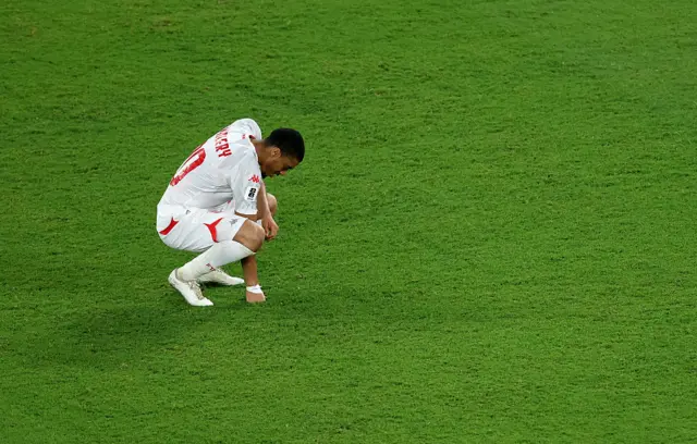 Tunisia player kneels