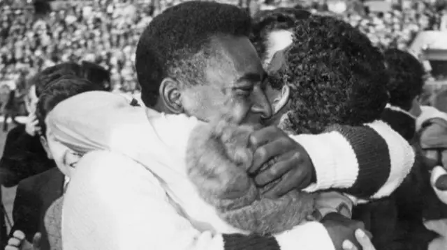 Pele hugs his team-mate.