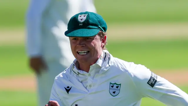 Ethan Brookes in the field with a green Worcestershire cap on