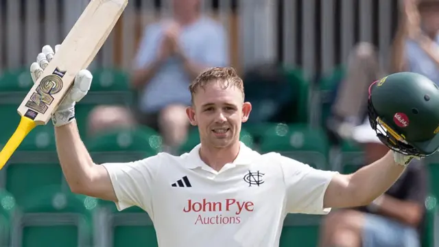Jack Haynes with bat in right hand and helmet in his left after scoring a century