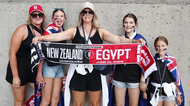 New Zealand fans with a New Zealand v Egypt half and half scarf outside the stadium