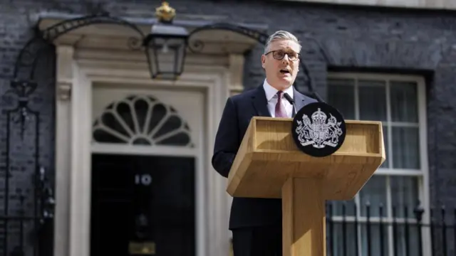 Keir Starmer speaks at a podium in front of 10 Downing Street during his resignation speech