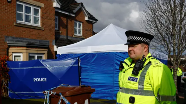 Police officer on guard outside Murrell's house