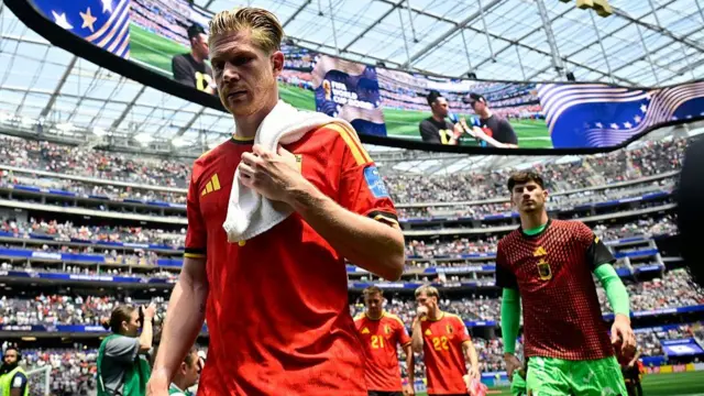 Kevin de Bruyne walks off the pitch disconsolate after Belgium's goalless draw against Iran