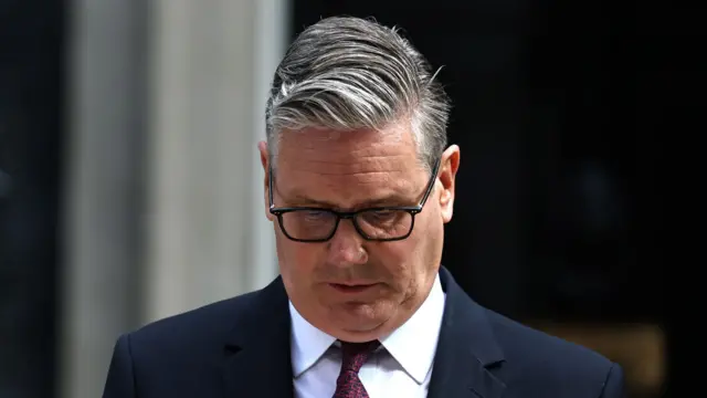 Sir Keir Starmer looks down as he announces his resignation on the steps of Downing Street