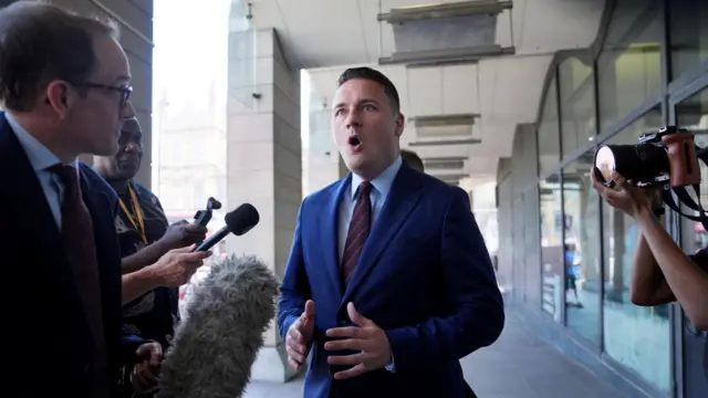 Wes Streeting spekaing to Chris Mason in front of Westminster