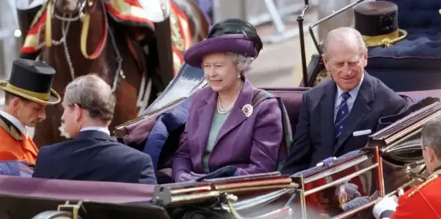 The late Queen and Prince Philip in a horse-drawn carriage